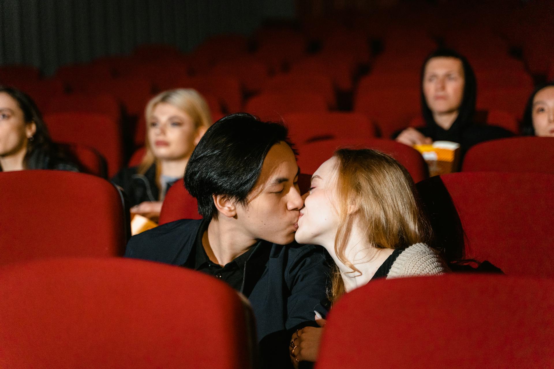 A couple kissing at the movies