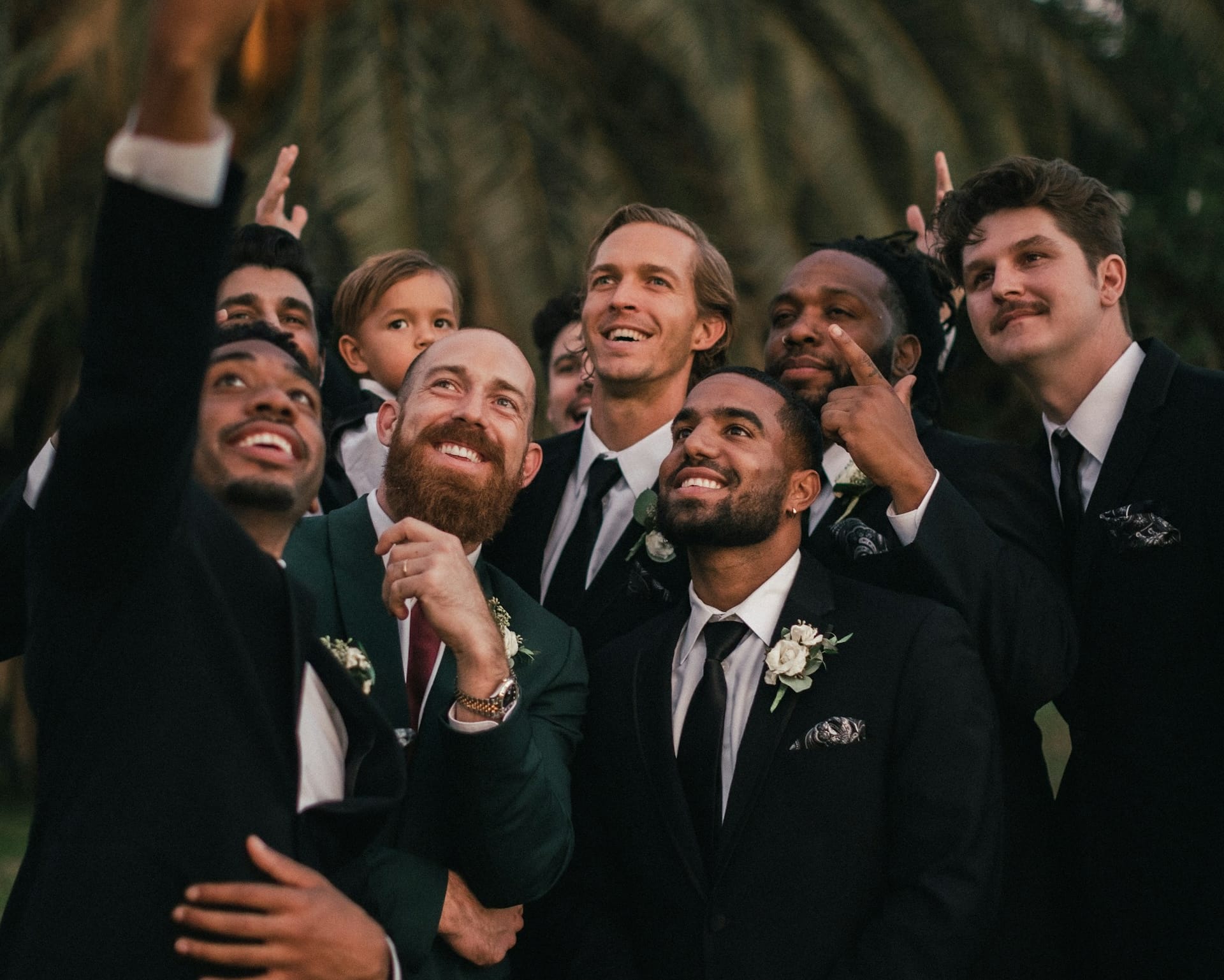 Men taking a selfie dressed for a black tie wedding